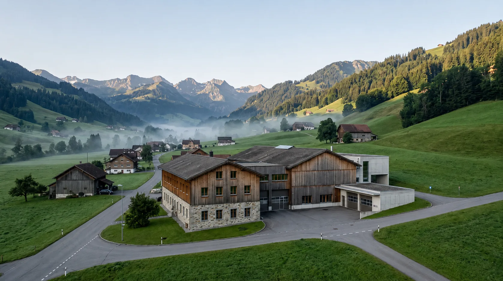 An Alpine industrial facility at golden hour, framed by the mountains